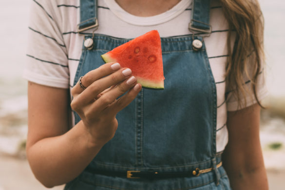 Girl holding slice of watermelon