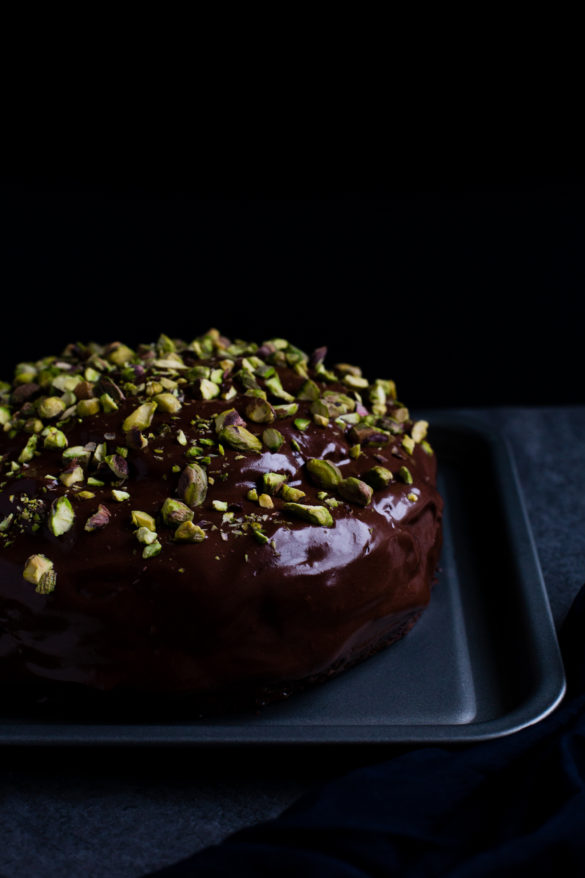 chocolate cake with pistachios on table